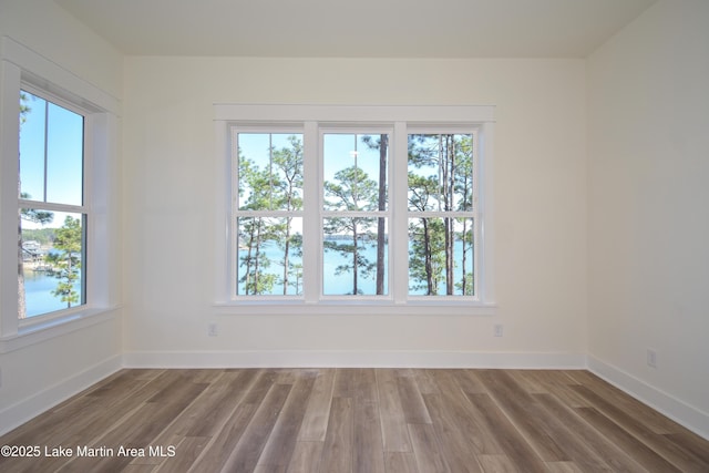 empty room featuring light wood finished floors and baseboards