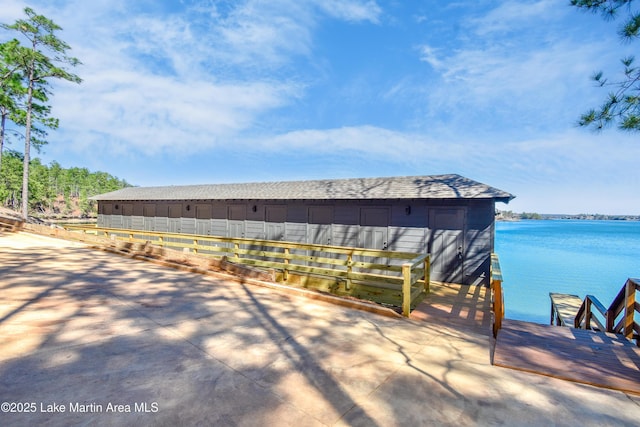 exterior space with a water view and a dock