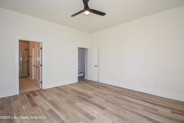 empty room with ceiling fan, light wood-type flooring, and baseboards