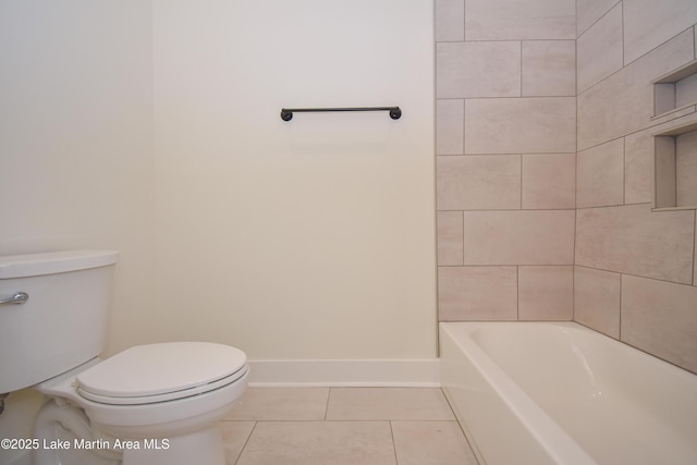 bathroom with tile patterned flooring, toilet, and baseboards