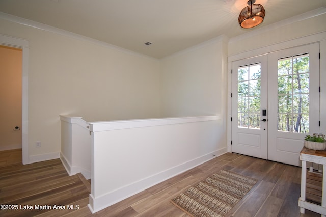 doorway to outside featuring baseboards, french doors, wood finished floors, and crown molding