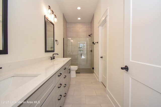 full bath with toilet, tile patterned flooring, a tile shower, and a sink