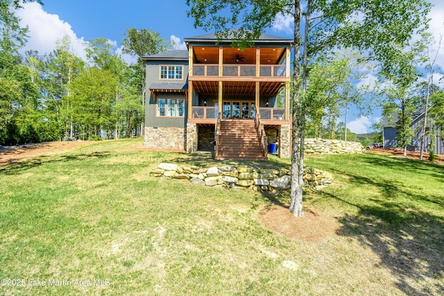 back of house with a yard, ceiling fan, a wooden deck, and stairway