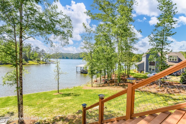 dock area featuring a water view and a lawn