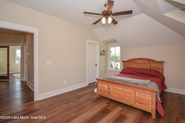 bedroom featuring lofted ceiling, baseboards, a ceiling fan, and dark wood-style floors