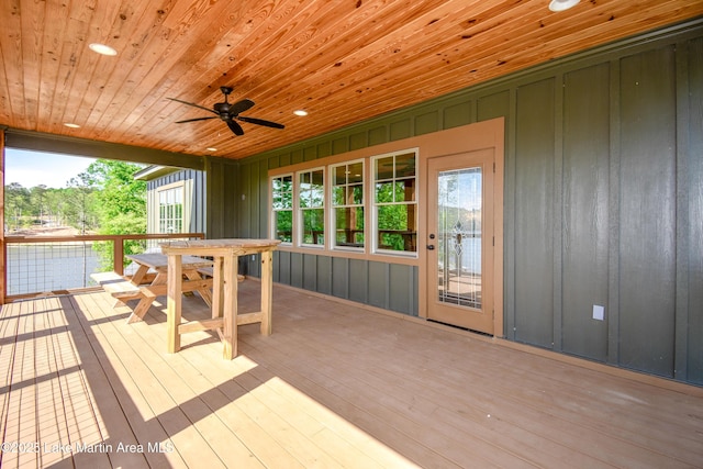 wooden terrace featuring a ceiling fan and outdoor dining space