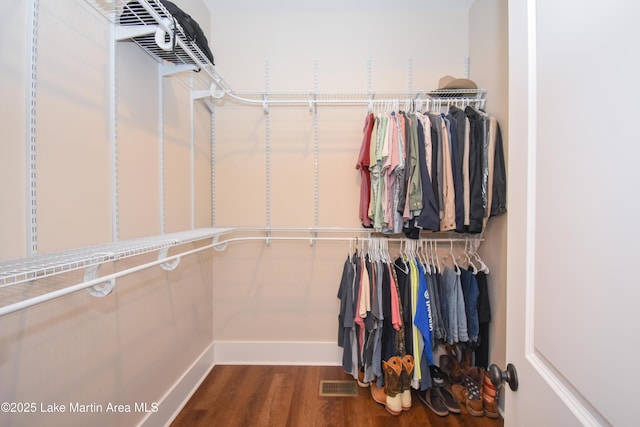 walk in closet featuring visible vents and wood finished floors