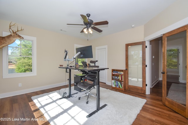office with baseboards, ceiling fan, visible vents, and wood finished floors