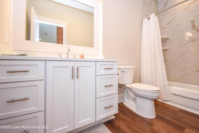 full bath with shower / bath combo with shower curtain, toilet, wood finished floors, and vanity