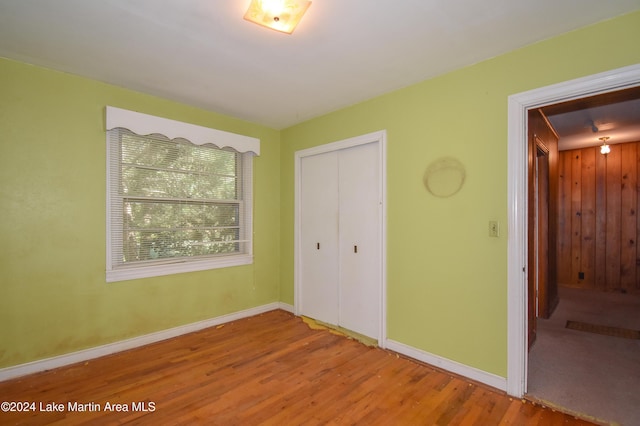 unfurnished bedroom featuring hardwood / wood-style floors and a closet