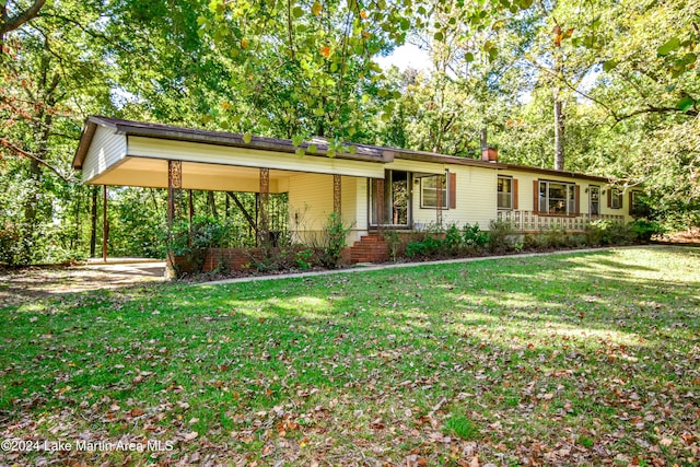 ranch-style home with a carport and a front lawn