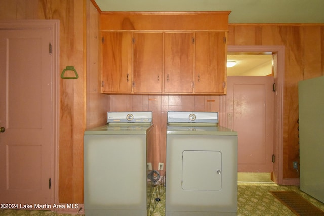 laundry room featuring cabinets and washing machine and dryer