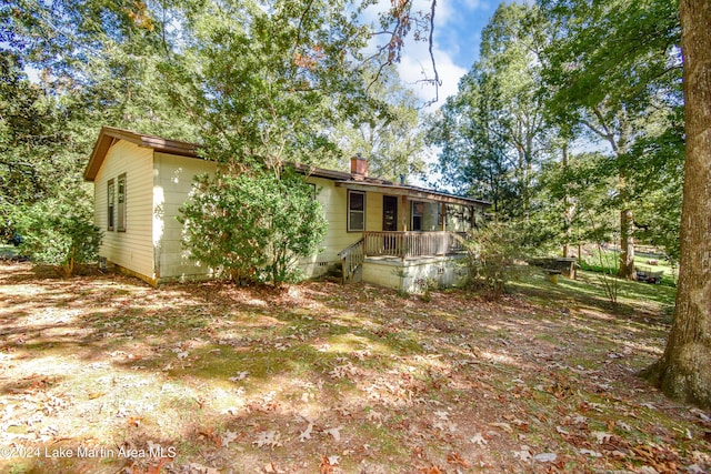 back of house featuring covered porch