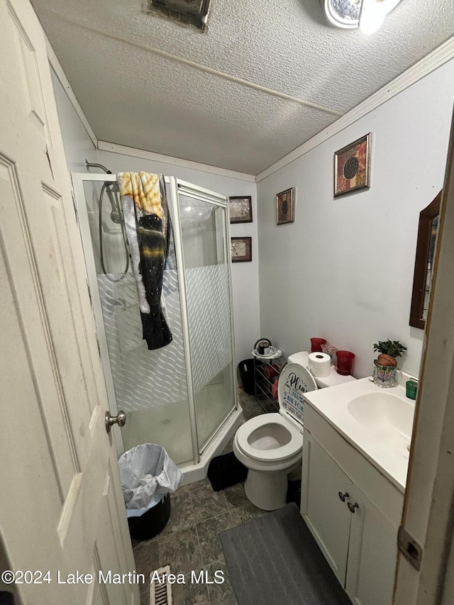 bathroom with vanity, a shower with door, tile patterned flooring, toilet, and a textured ceiling