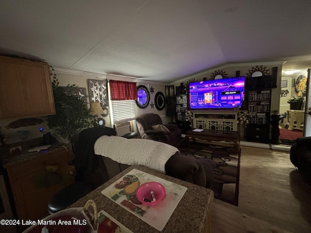 living room with hardwood / wood-style flooring, vaulted ceiling, cooling unit, and crown molding