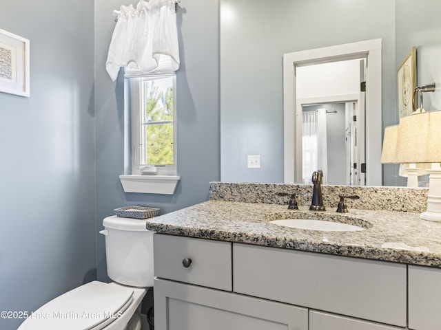 bathroom with vanity and toilet