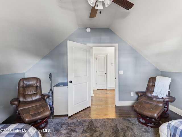 living area with lofted ceiling, dark hardwood / wood-style flooring, and ceiling fan