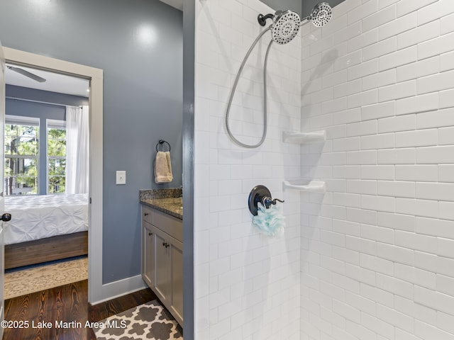 bathroom featuring vanity, tiled shower, and hardwood / wood-style floors