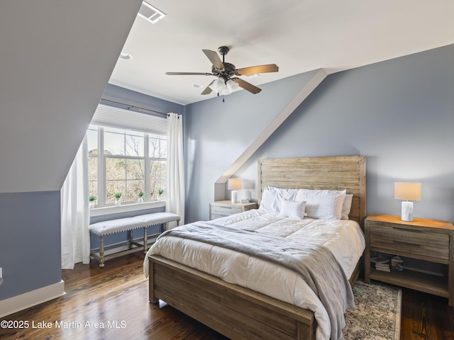 bedroom featuring dark wood-type flooring, ceiling fan, and vaulted ceiling