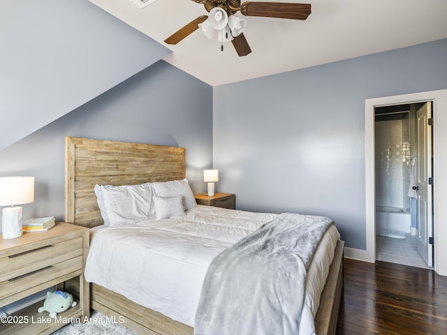 bedroom featuring ensuite bathroom, dark hardwood / wood-style flooring, lofted ceiling, and ceiling fan