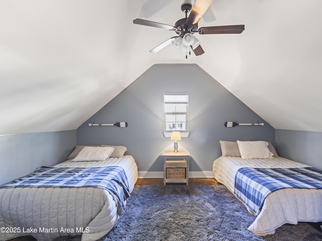 bedroom with lofted ceiling, dark hardwood / wood-style floors, and ceiling fan