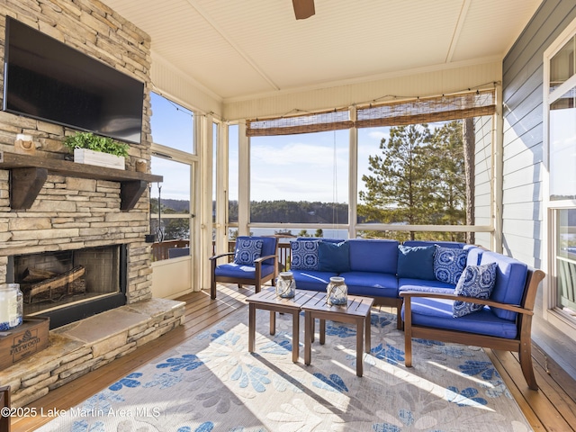 sunroom / solarium with an outdoor stone fireplace