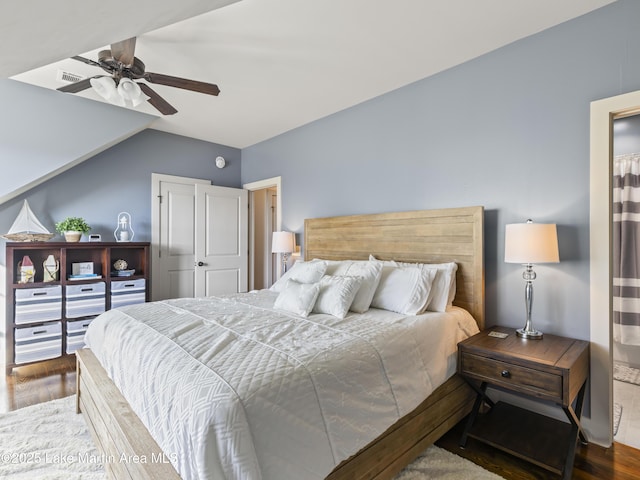 bedroom featuring lofted ceiling, dark wood-type flooring, and ceiling fan