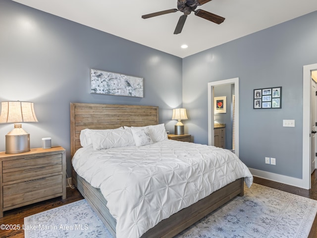 bedroom featuring connected bathroom, dark hardwood / wood-style floors, and ceiling fan