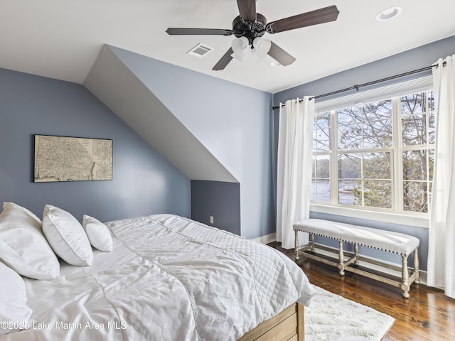 bedroom with ceiling fan, dark hardwood / wood-style flooring, and vaulted ceiling