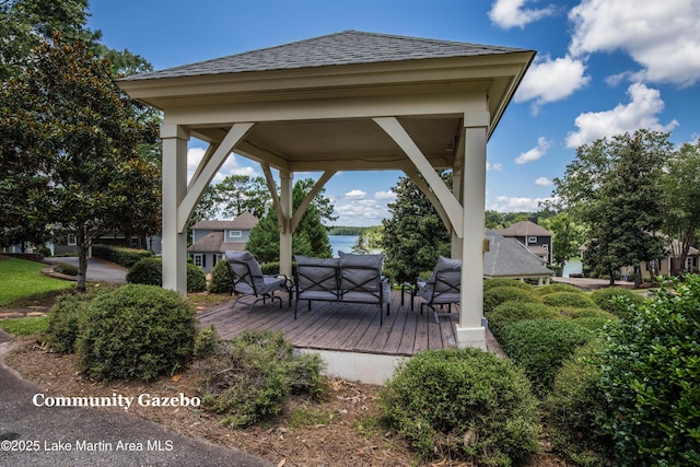 view of patio / terrace with a gazebo, a deck with water view, and outdoor lounge area