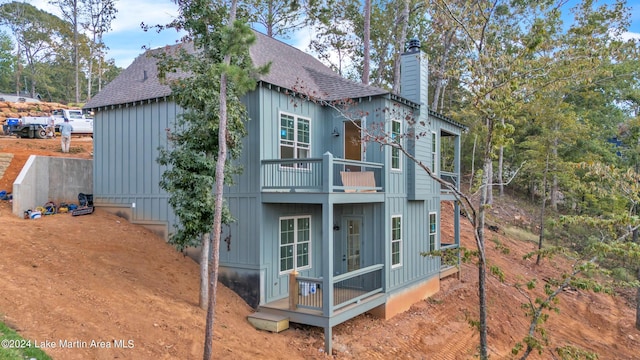 back of house featuring a balcony