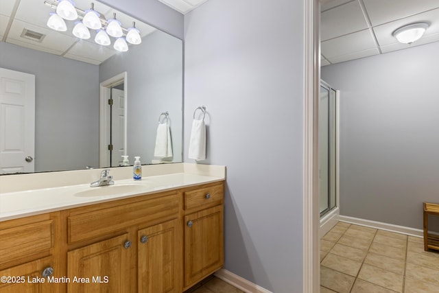 310 Hillwood, Dadeville, AL 36853 - bathroom with a paneled ceiling, vanity, a stall shower, and tile patterned floors