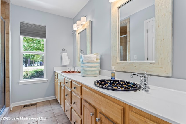 310 Hillwood, Dadeville, AL 36853 - full bathroom with double vanity, tiled shower, and tile patterned floors