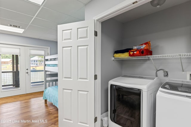 310 Hillwood, Dadeville, AL 36853 - laundry area with washer and clothes dryer, french doors, and wood finished floors
