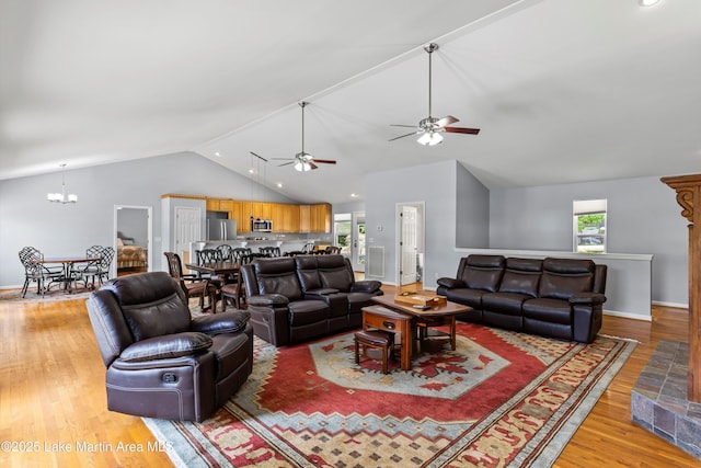 310 Hillwood, Dadeville, AL 36853 - living room featuring ceiling fan, light wood-style floors, a chandelier, plenty of natural light, and high vaulted ceiling