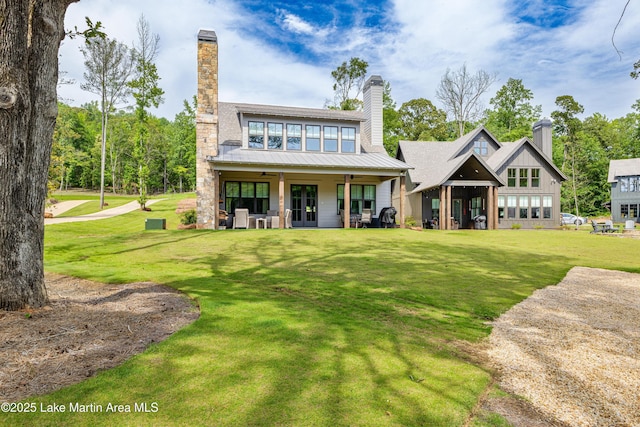 285 Magnolia Way, Dadeville, AL 36853 - rear view of property with a chimney, a lawn, ceiling fan, and metal roof