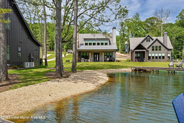 285 Magnolia Way, Dadeville, AL 36853 - back of property featuring board and batten siding, a chimney, a yard, a water view, and cooling unit
