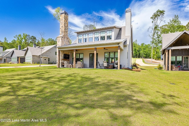 285 Magnolia Way, Dadeville, AL 36853 - rear view of property featuring a chimney, ceiling fan, a yard, metal roof, and a standing seam roof
