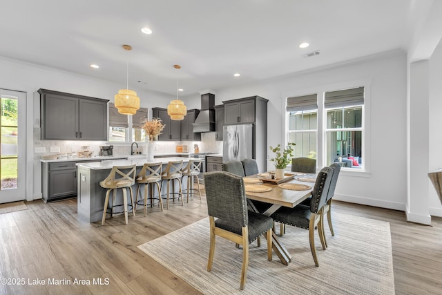 285 Magnolia Way, Dadeville, AL 36853 - dining area featuring healthy amount of natural light, light wood-style floors, recessed lighting, crown molding, and baseboards