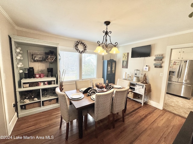 dining area with a notable chandelier, dark hardwood / wood-style floors, and crown molding