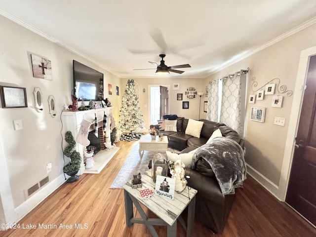 living room with hardwood / wood-style floors, ceiling fan, and ornamental molding