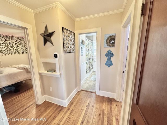 doorway featuring ornamental molding and light wood-type flooring