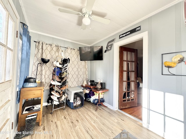 interior space with hardwood / wood-style floors, ceiling fan, and crown molding