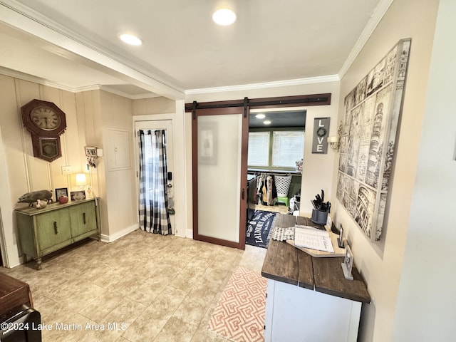 interior space with a barn door and crown molding