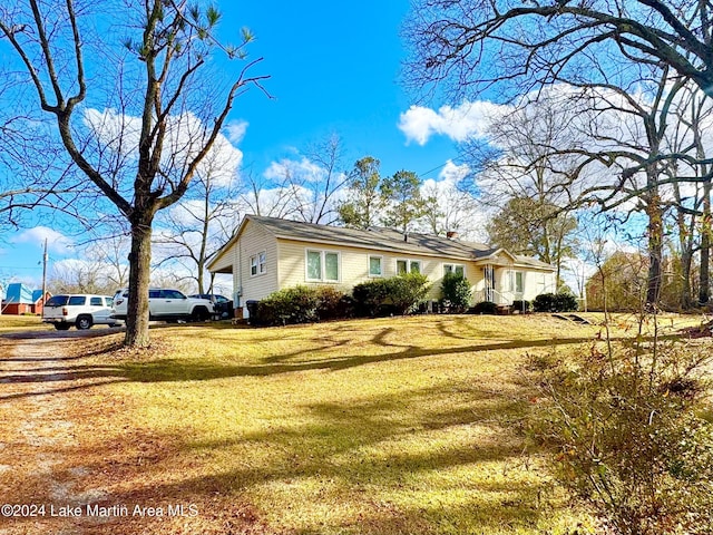 view of side of home featuring a lawn