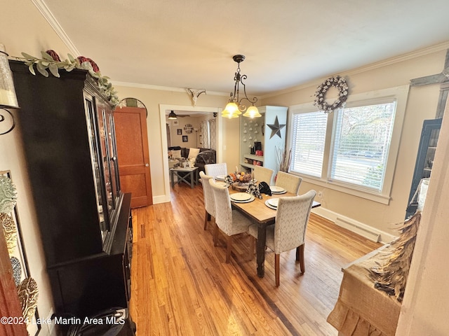 dining room with ceiling fan with notable chandelier, light wood-type flooring, and crown molding