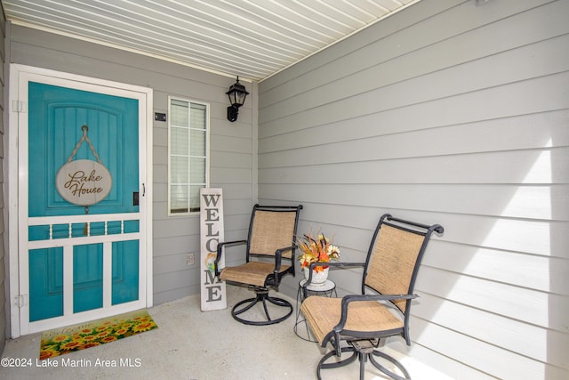 view of exterior entry with a porch