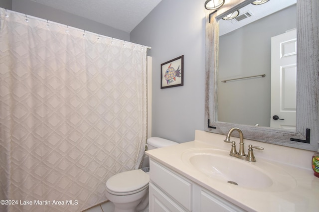 bathroom with curtained shower, vanity, a textured ceiling, and toilet