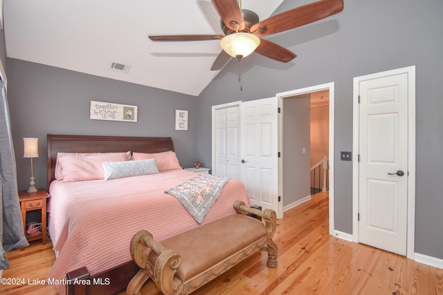 bedroom with ceiling fan, light hardwood / wood-style floors, and lofted ceiling