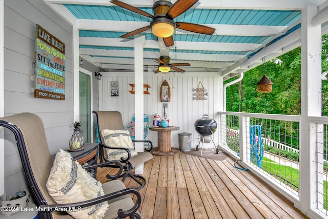 sunroom with beamed ceiling and ceiling fan